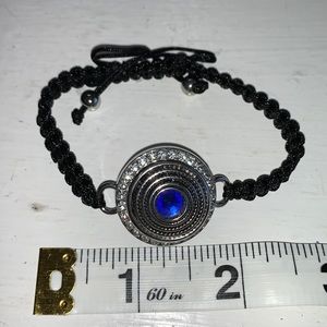 Adjustable braided black cord bracelet with one interchangeable snaps.NWOT